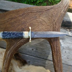 FOSSIL CORAL AND WARTHOG HANDLE DAMASCUS DAGGER